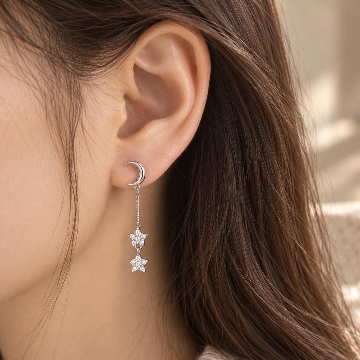 Moon and star dangle earring worn on the ear