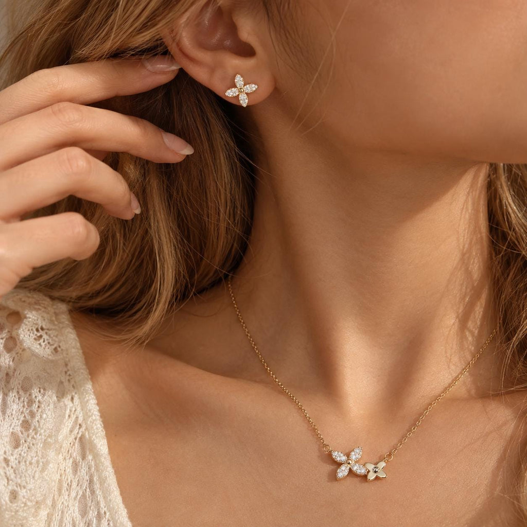 Four leaf clover necklace and stud earrings worn by a model